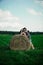 Lovers resting in a field near haystacks