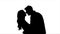 Lovers talk and try to kiss, flirt and start kissing each other. Silhouette. White background