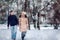 Lovers walking in winter snow- Smiling Couple in Winter Park having fun..