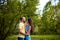 Lovers. A young couple. The guy with the girl are walking in the forest. Loving couple hugs sensually. Lovers man and woman in the