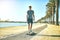 He loves being in the sun. Full length shot of a young boy skating on a pathway alongside a lagoon.