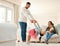 She loves dancing with dad. a little girl playing with her father at home.