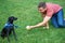 He loves a good game of catch. A young man playing with his dog outdoors.