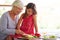 She loves helping granny. a little girl helping her grandmother make lunch.