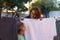 She loves helping her mom. a mother looking over at her daughter from behind a washing line.