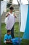 He loves helping his granny. a grandmother and grandchild hanging laundry together.