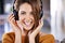 She loves her music. Beautiful young woman listening to music at home.