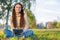 She loves her tunes. An attractive young woman listening to music on her digital tablet while outdoors.