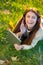 She loves her tunes. An attractive young woman listening to music on her digital tablet while outdoors.