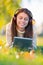 She loves her tunes. An attractive young woman listening to music on her digital tablet while outdoors.