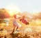 She loves playing with her teddy in nature. an adorable little girl playing with her teddybear outdoors.