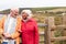 Loving Active Senior Couple Resting By Gate As They Walk Along Coastal Path In Winter