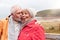 Loving Active Senior Couple Resting By Gate As They Walk Along Coastal Path In Winter