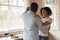 Loving african American couple dancing enjoy date at home