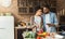 Loving african-american couple preparing salad and drinking red wine