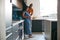 Loving African American Husband With Pregnant Wife At Home In Kitchen Together