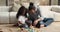 Loving african dad play wooden cubes with adorable daughter