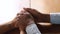Loving african husband holding hands of wife give support, closeup