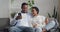 Loving afro american ethnic couple sitting on sofa at home talking spending time together at holidays. Mixed race smiled