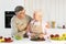 Loving Aged Husband Hugging Wife While Making Dinner In Kitchen