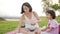 Loving asian chinese mother and daughter having picnic by the beach preparing food