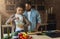 Loving black couple preparing dinner in kitchen