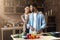 Loving black couple preparing salad in loft kitchen