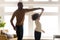 Loving black dad and daughter dance together at home