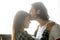 Loving boyfriend kissing girlfriend on forehead enjoying intimat