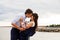 Loving bride and groom kissing on the pier.