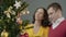 Loving couple admiring merry twinkling of festive lights standing in embrace