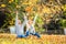 A loving couple in an autumn park lies on the leaves