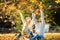 A loving couple in an autumn park lies on the leaves