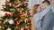 Loving couple on the background of the Christmas tree. Christmas portrait of lovers