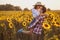 Loving couple in a blooming sunflower field