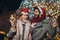 Loving couple burning sparklers by holiday illumination on new years eve