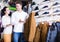 Loving couple deciding on warm suit in sports store