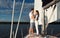 Loving Couple Embracing Standing On Sailboat Sailing On River Outdoor