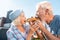 Loving couple feeling funny eating one croissant together outside their house