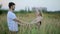 A loving couple. Guy kisses a woman and then jokingly drops her. Fun young man and woman holding hands and whirling in the field