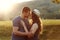 Loving couple kissing at sunset in nature, honeymoon, mountains, back light, soft light, emotions, happiness,