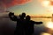 Loving couple makes selfie at sunset near the lake. Lens flare effect