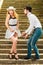 Loving couple retro style flirting on stairs