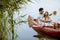 Loving couple rowing on the lake