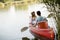 Loving couple rowing on the lake