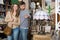 Loving couple in shop of secondhand furniture
