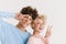 Loving couple showing peace gesture