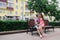 Loving couple sitting on a bench on a mall on a sunny day