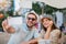 Loving couple sitting in a cafe enjoying in coffee and make selfie photo