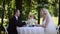 Loving couple sitting at a table alone in the forest. Sequence